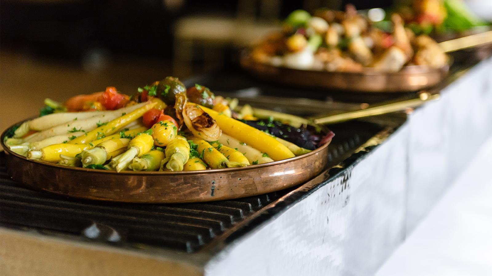 Squash and carrots on a stove.