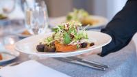 Server placing down a salad
