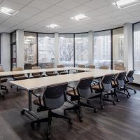 Conference Room 103A with U-shaped long table, chairs, and large windows, after renovation